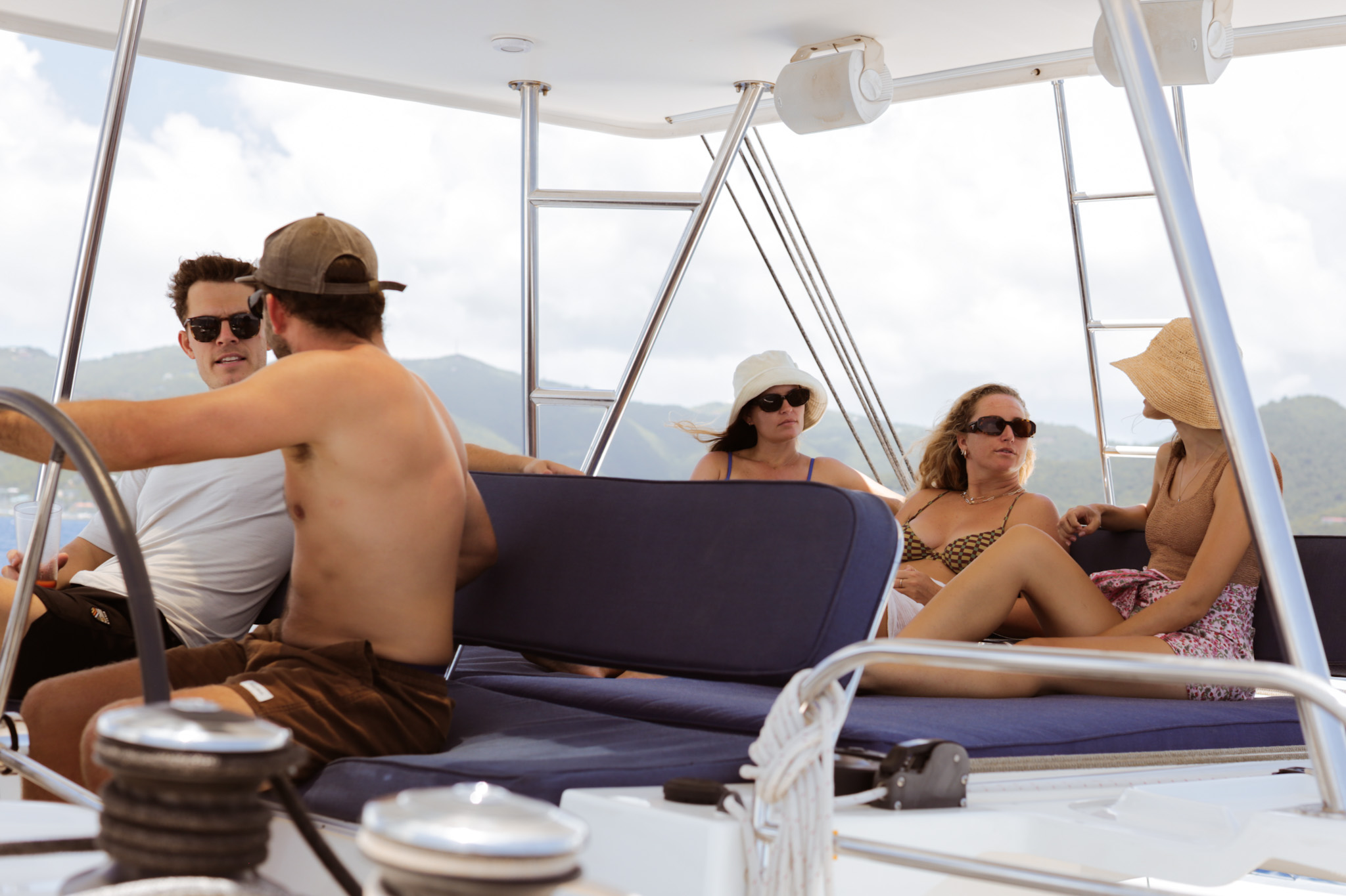Guests relaxing aboard a TMM catamaran during a BVI yacht charter in the British Virgin Islands.