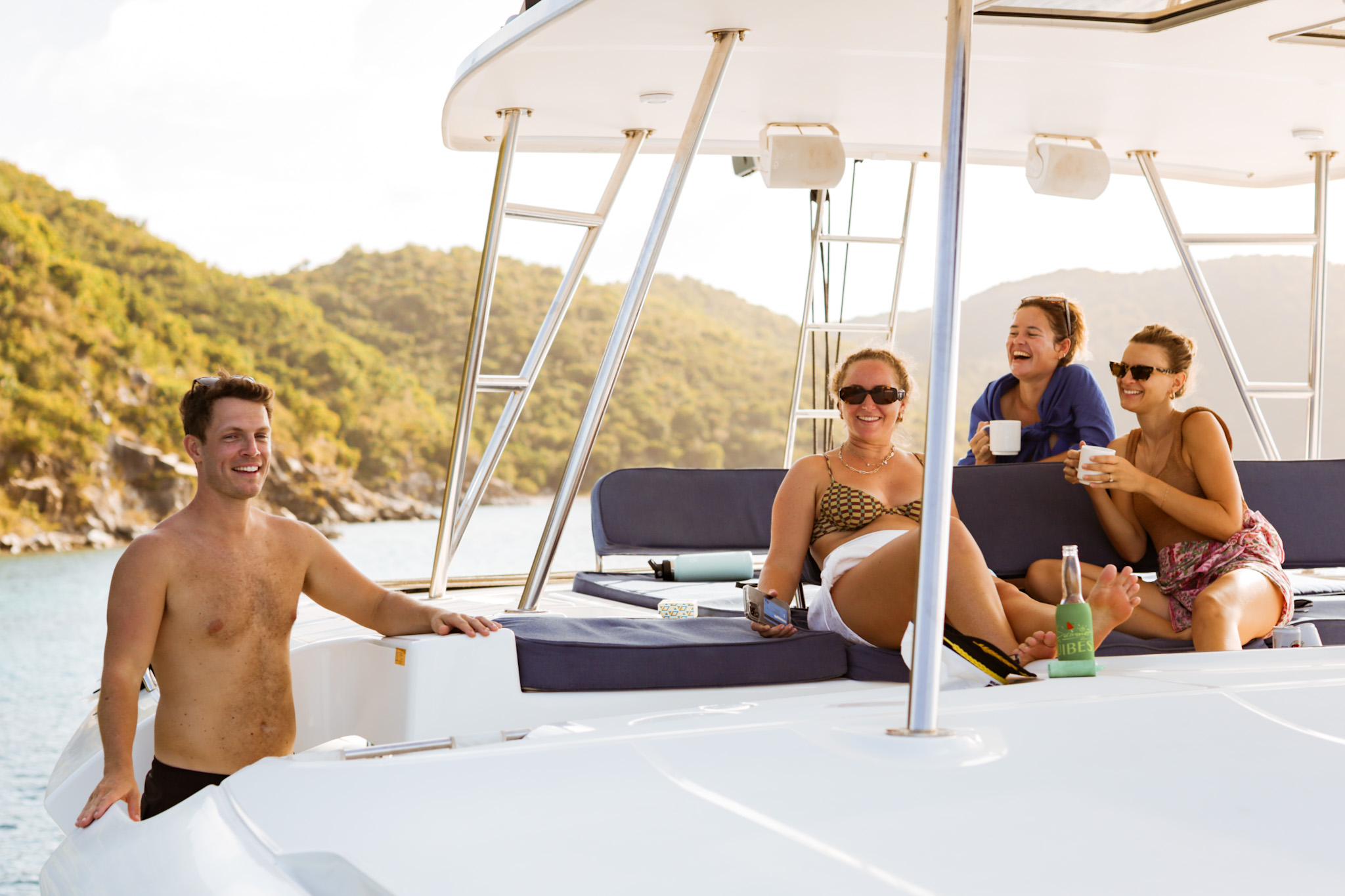Guests relaxing on a catamaran and enjoying a morning in a sheltered BVI anchorage