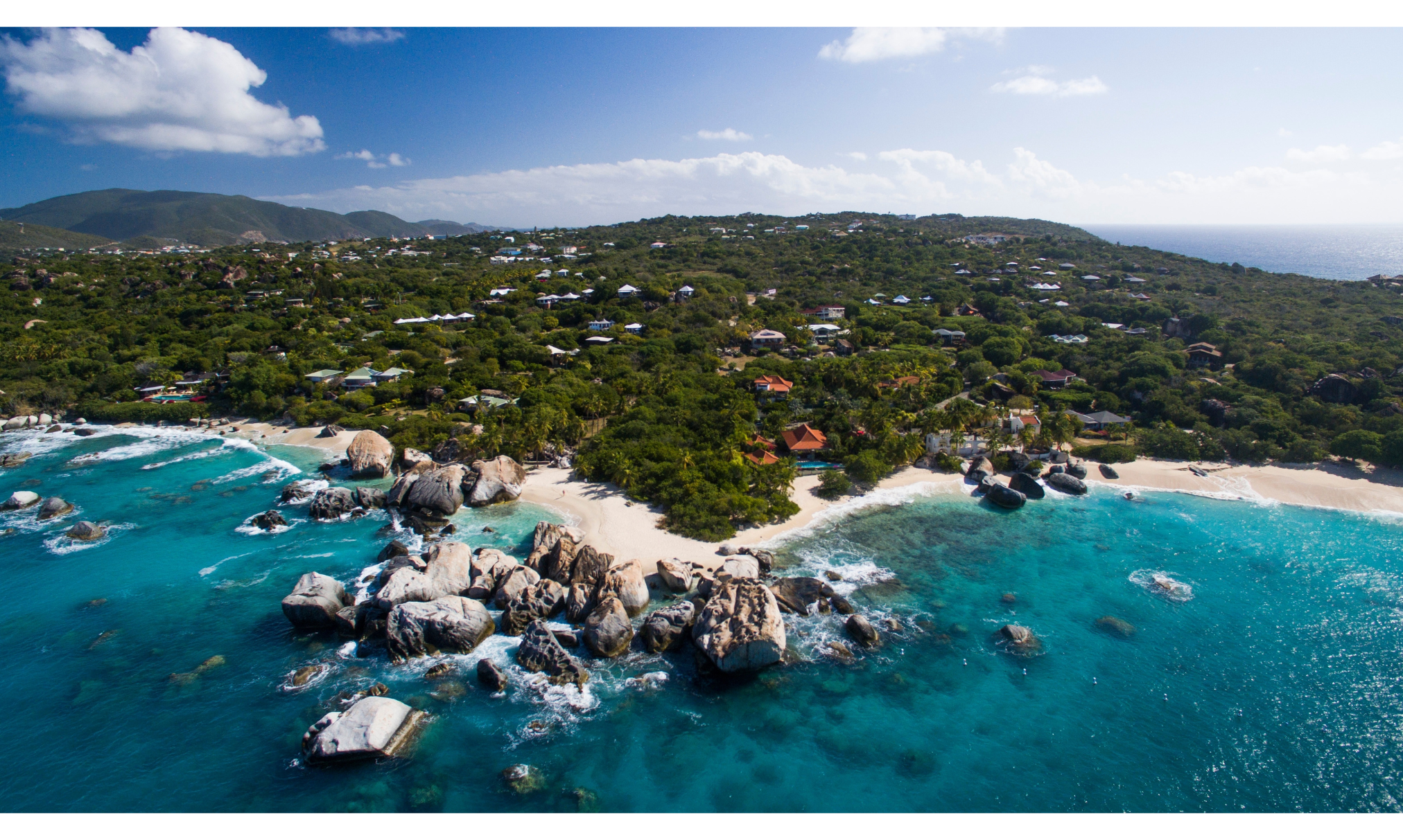 Aerial view of Virgin Gorda's rocky coastline, white sand beaches and crystal-clear Caribbean waters.