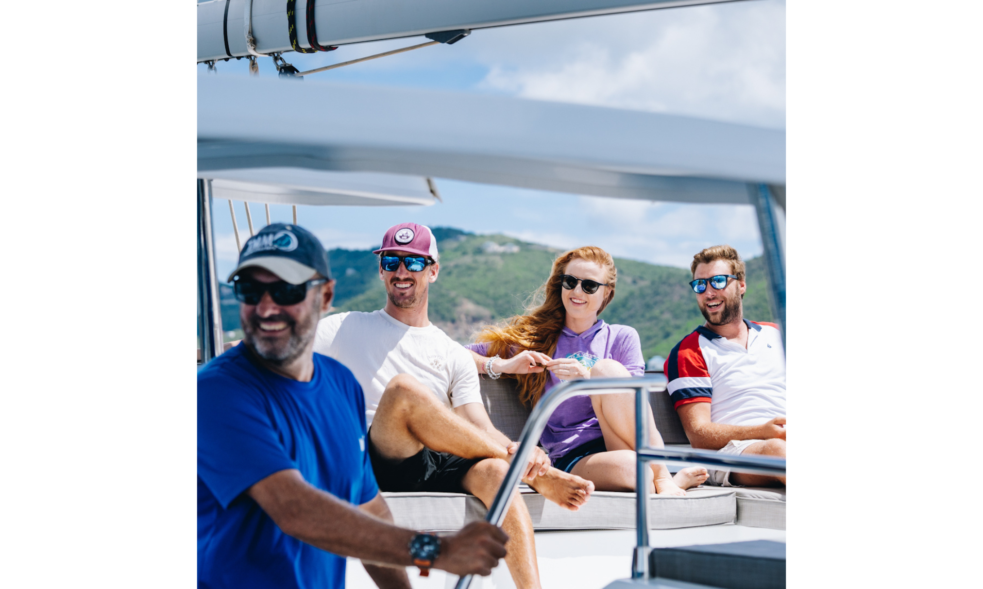 A skipper and guests enjoying a catamaran cruise through the Caribbean.